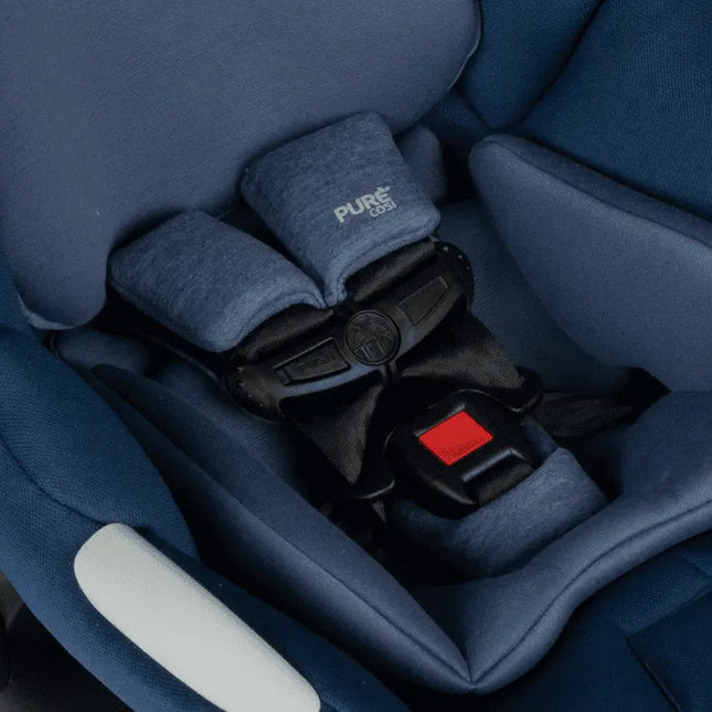Close-up of a blue car seat with a visible brand logo, showing the harness system.