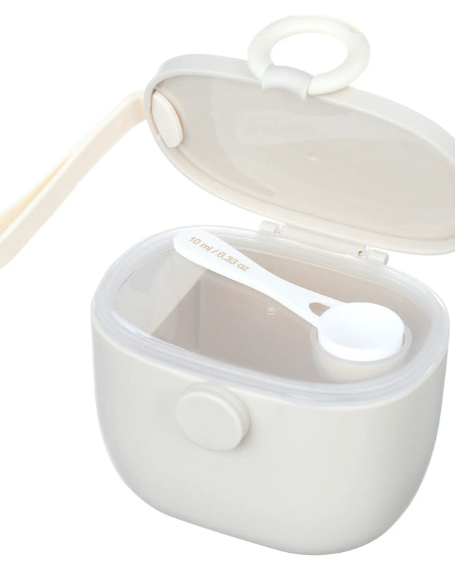 White baby food container with spoon on a white background