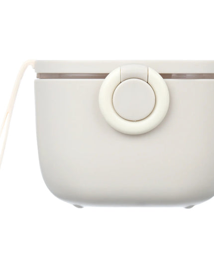 White silicone formula dispenser container with a lid on a white background