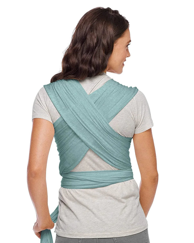 Woman wearing a teal baby carrier on a white background