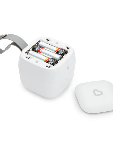 White electronic device with batteries and a heart-shaped button on a white background