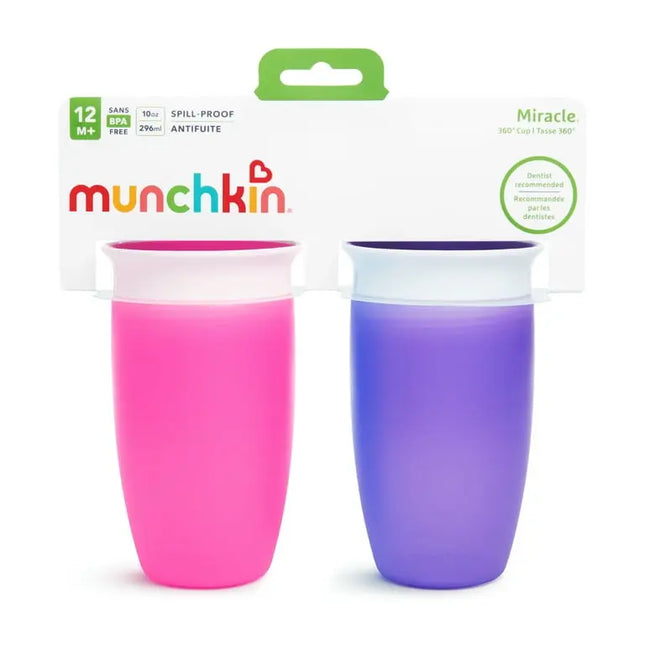 Two Munchkin Miracle 360 sippy cups, one pink and one purple, in front of their packaging.