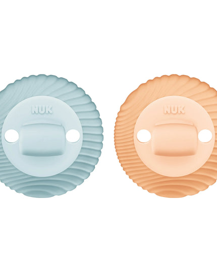 Two pacifiers, one blue and one peach, on a white background