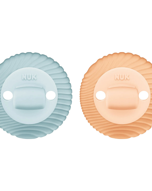 Two pacifiers, one blue and one peach, on a white background