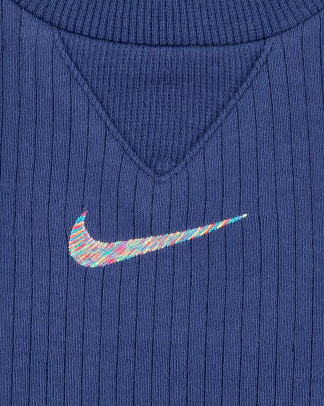 Close-up of a blue ribbed sweater with a colorful Nike logo.