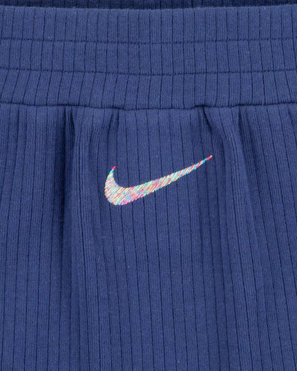 Blue ribbed fabric with a colorful Nike logo on a close-up of a garment.