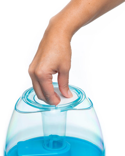 Hand interacting with a blue and clear container on a white background