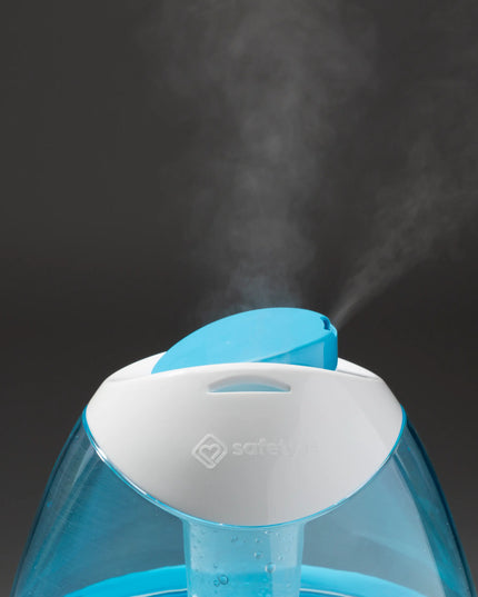 Blue humidifier emitting steam on a dark background