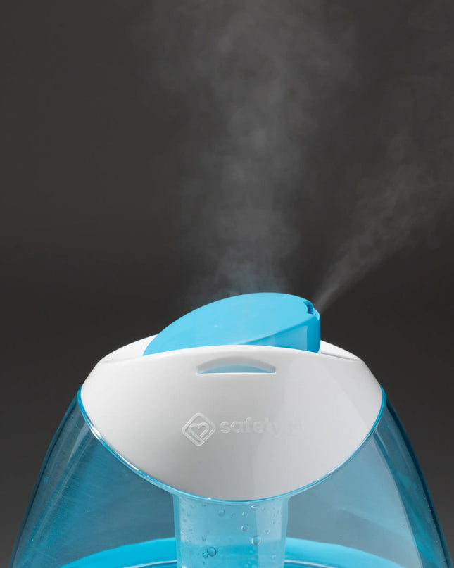 Blue humidifier emitting steam on a dark background