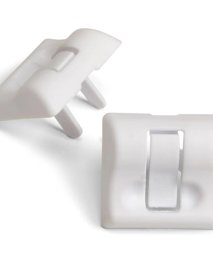 Two white plastic clips on a white background