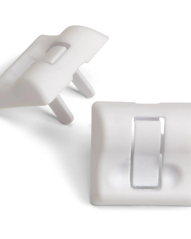 Two white plastic clips on a white background