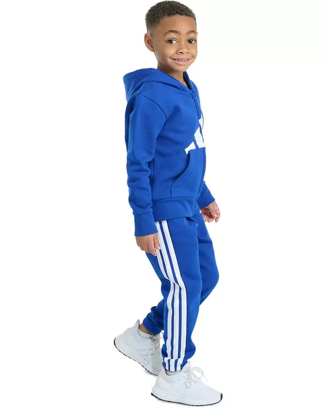 Child wearing a blue tracksuit with white stripes on a white background