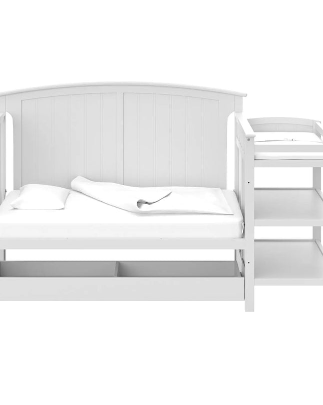 White crib with changing table on a white background