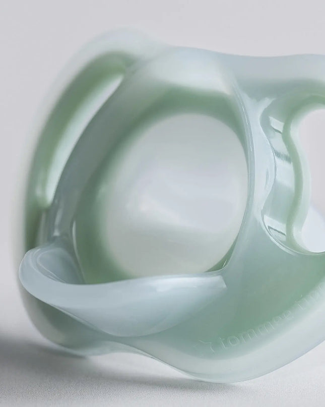 Silicone pacifier on a light gray background