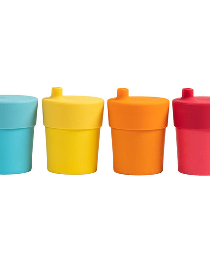 Four colorful sippy cups in blue, yellow, orange, and red on a white background