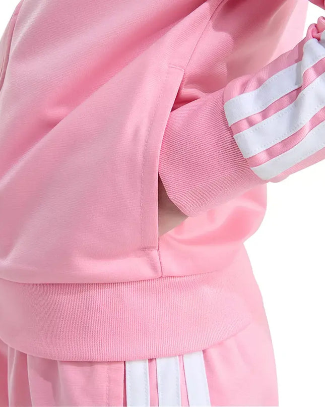 Close-up of a pink tracksuit with white stripes on a white background