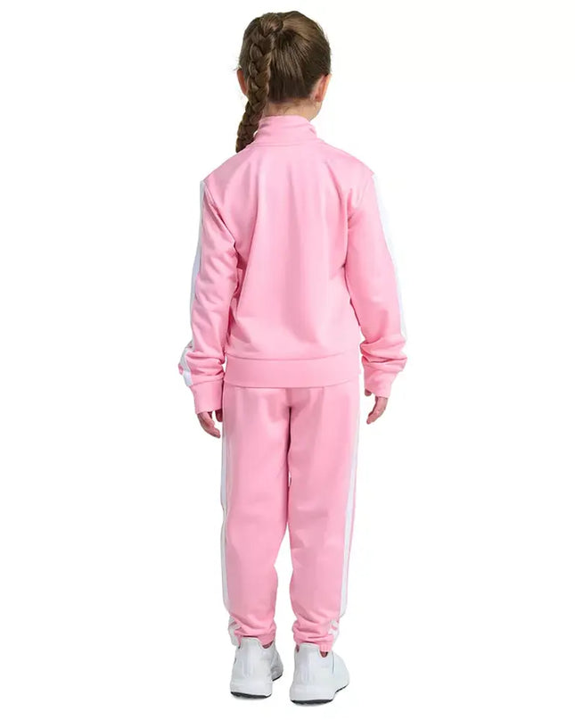 Child wearing a pink tracksuit on a white background