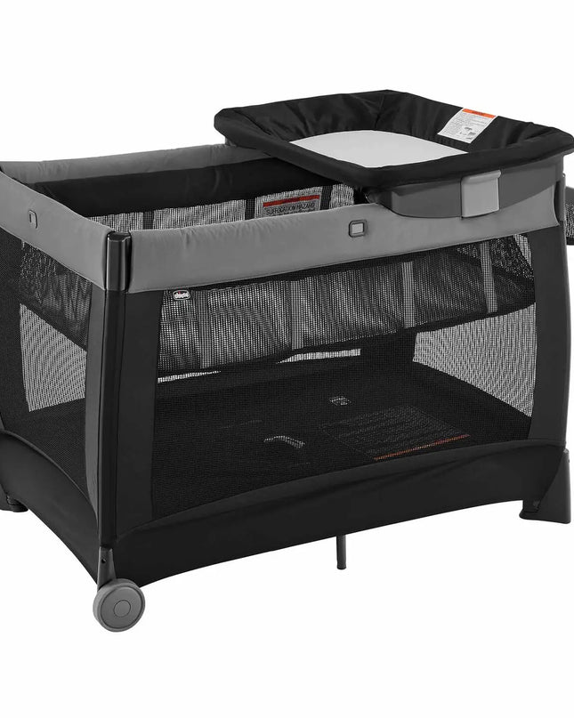 Black and gray baby playpen with attached changing table on a white background